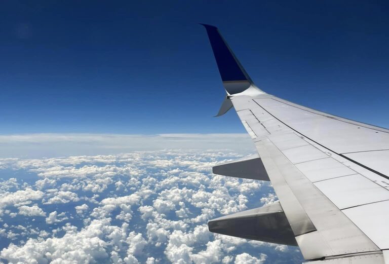 wing shot with puffy clouds