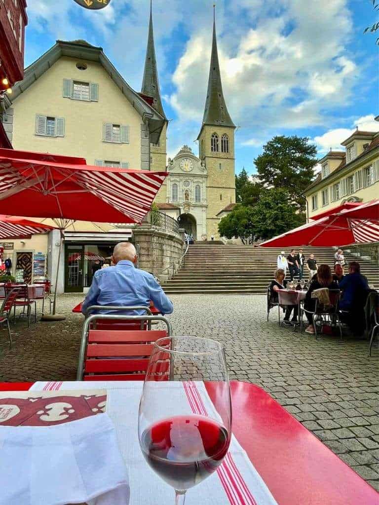 Enjoy a glass of wine at the steps of the church of St. Leodegar.