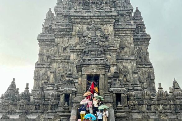 People with umbrellas at Prambanan Temple