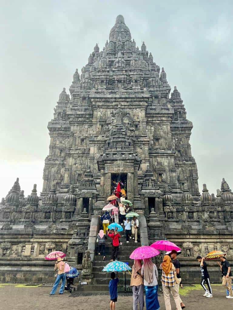 People with umbrellas at Prambanan Temple