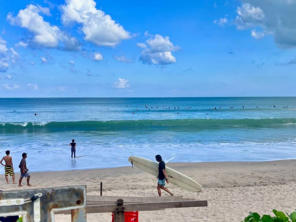 surfer walking on beach