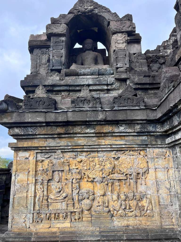 Intricate carved relief in the stone wall of Borobudur Temple