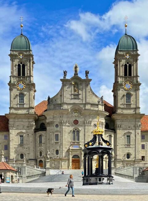 Person walking in front of Einsiedeln Abbey