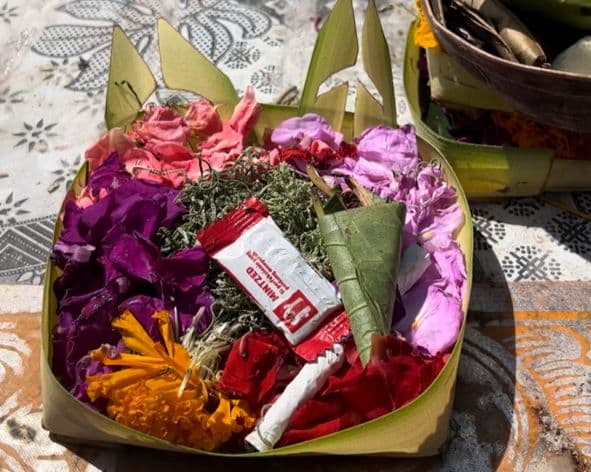 Balinese offering with candy and flowers