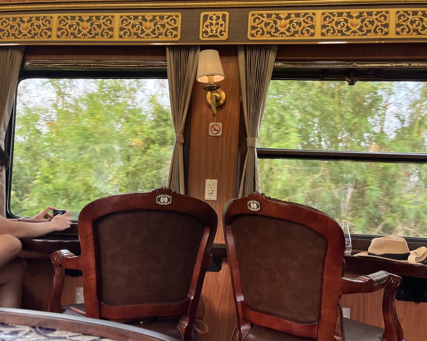 Seats 8 and 9 in the VIP carriage, showing the split emergency exit window beside seat 8.